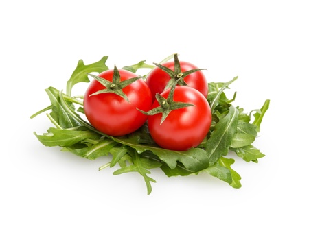 fresh rucola leaves with cherry tomatoes, isolated on whiteの写真素材