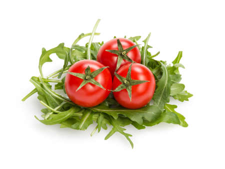 fresh rucola leaves with cherry tomatoes, isolated on whiteの写真素材