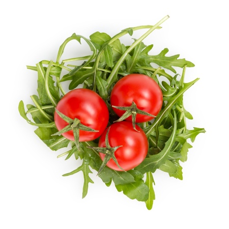 fresh rucola leaves with cherry tomatoes, isolated on whiteの写真素材