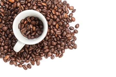 heap of coffee beans with cup, isolated on whiteの写真素材