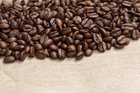 heap of coffee beans on burlap, backgroundの写真素材