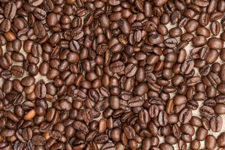 heap of coffee beans on burlap, backgroundの写真素材