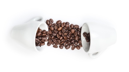 heap of coffee beans with two cups, isolated on whiteの写真素材