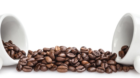 heap of coffee beans with two cups, isolated on whiteの写真素材