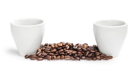 heap of coffee beans with two cups, isolated on whiteの写真素材