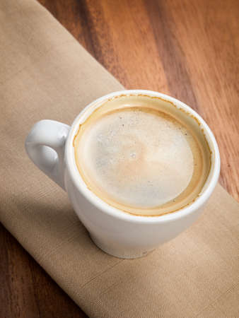 espresso in a cup on burlap surfaceの写真素材