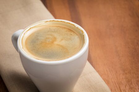 espresso in a cup on burlap surfaceの写真素材