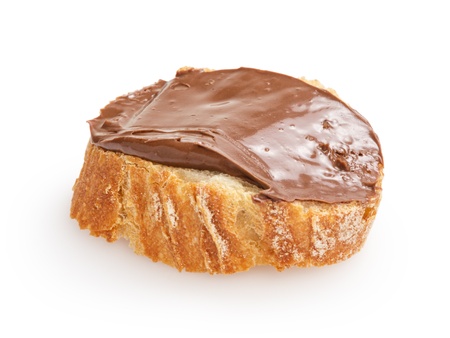 baguette slice spread with nut-choco paste, isolated on whiteの写真素材
