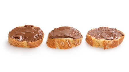 baguette slices spread with nut-choco paste, isolated on whiteの写真素材