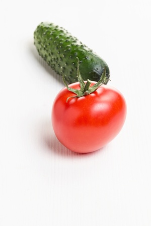 tomato and cucumber, on white wooden tableの写真素材