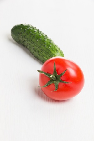 tomato and cucumber, on white wooden tableの写真素材