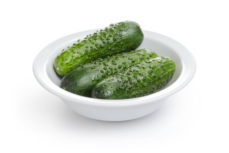 fresh greenhouse cucumbers in bowl, isolated on white backgroundの写真素材