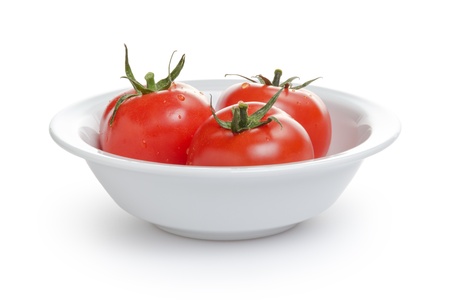 fresh tomatoes in bowl, isolated on whiteの写真素材