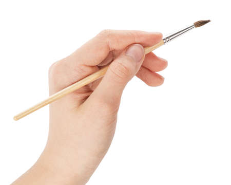 female teen hand with a brush on white backgroundの写真素材