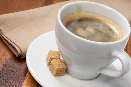 cup of espresso with cane sugar, on tableの写真素材