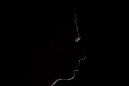 low key portrait silhouette of man looking or thinking