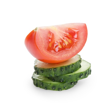 sliced tomato and cucumber, isolated on whiteの写真素材
