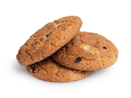 heap of oat cookies with raisins, isolated on whiteの写真素材
