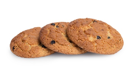 heap of oat cookies with raisins, isolated on whiteの写真素材