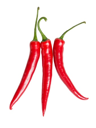 three red chili peppers, isolated on whiteの写真素材