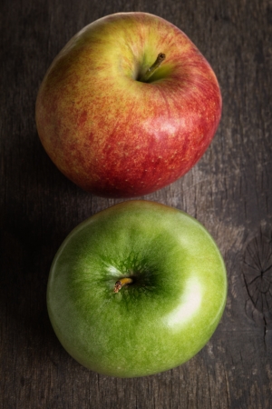 two ripe garden apples close up, on old wood tableの写真素材