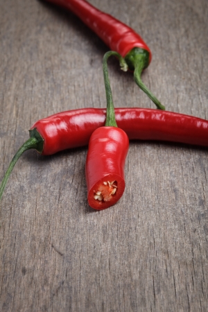 red chili peppers, on old wooden backgroundの写真素材