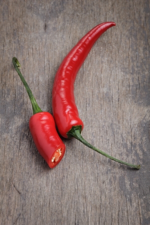 red chili peppers, on old wooden backgroundの写真素材