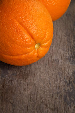 ripe round orange on wooden table, selective focusの写真素材