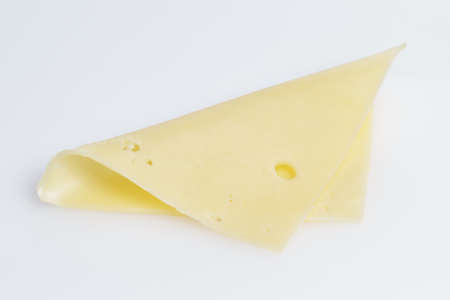 square slices of edam cheese, on gray backgroundの写真素材
