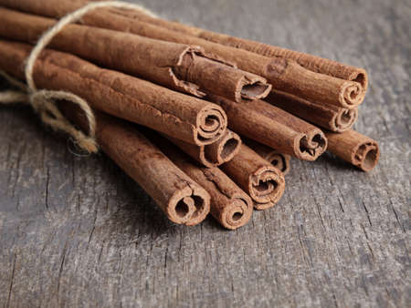 cinnamon sticks on old wooden table, selective focusの写真素材