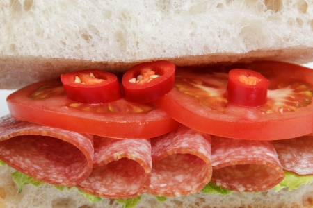 spicy italian sandwich with salami, close upの写真素材