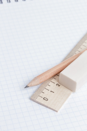 school supplies on notebook page, school or business backgroundの写真素材