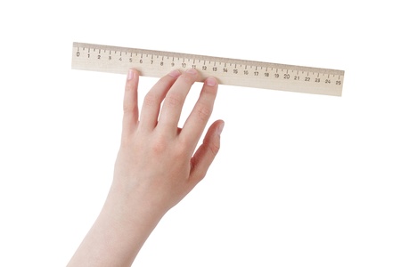 female teen hand holding natural wood ruler, isolated on whiteの写真素材