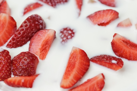 slices of strawberry in milk, close up photoの写真素材