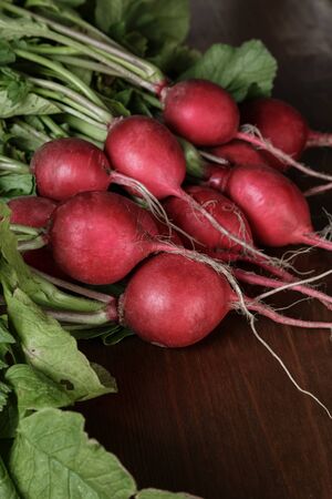 heap of ripe radishes, on wood tableの写真素材