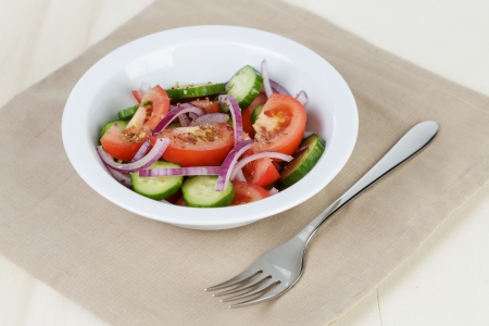 served plate with mix salad from tomatoes and cucumbers on tableの写真素材