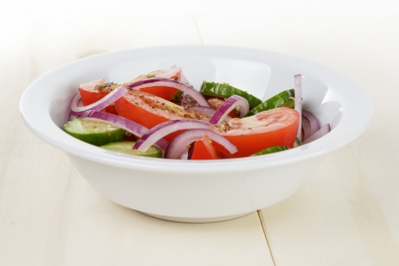 mix salad from tomatoes cucumbers and onion, on tableの写真素材