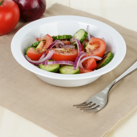 served plate with mix salad from tomatoes and cucumbers on tableの写真素材