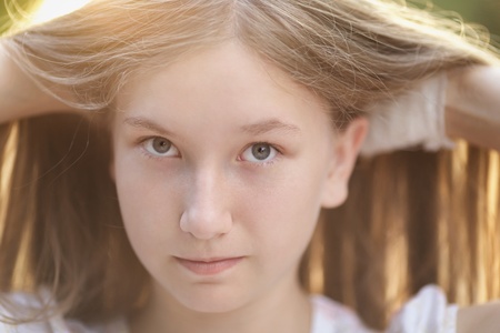 close up portrait of attractive teen girl in sunset, backlightedの写真素材