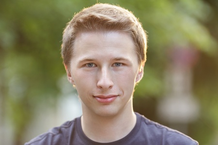 portrait of handsome adult man, with blured natural backgroundの写真素材