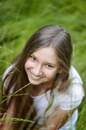 portrait of beautiful teen girl on the grass, upper pointの写真素材