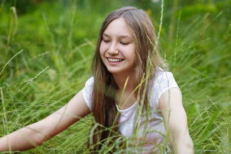 portrait of beautiful teen girl on the grass, upper pointの写真素材