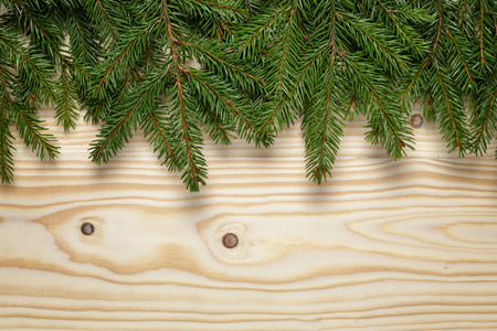 christmas from fir twigs on wooden table, horizontal