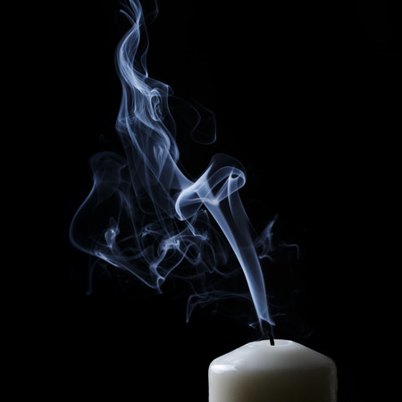 extinguished candle with blue smokeの写真素材