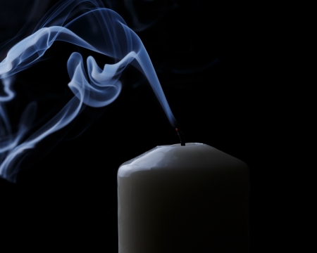 extinguished candle with blue smokeの写真素材