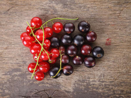 organic garden berries on old wood table, from above