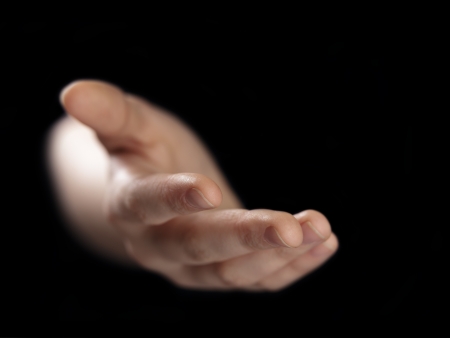 female elping hand from darkness, selective focusの写真素材