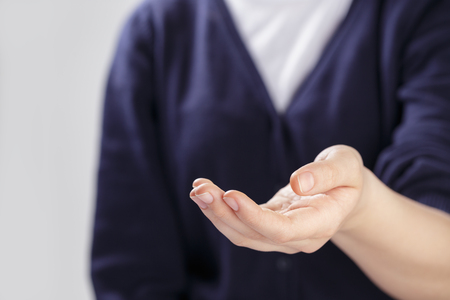 female teen hand to presenting or showing something, selective focusの写真素材