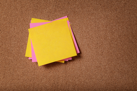 bunch of empty sticky notes on cork boardの写真素材