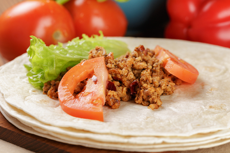 wheat tortillas with ingridients for burrito on old wooden table rustic styleの写真素材